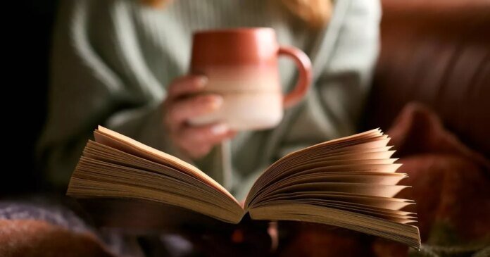 0_close-up-of-woman-at-home-in-winter-jumper-with-warming-hot-drink-in-mug-reading-book